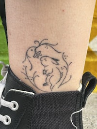 a woman's ankle with a tattoo on it