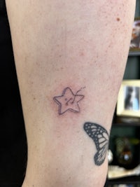 a small star tattoo on a person's arm