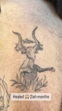 a tattoo of a goat on a man's thigh