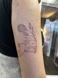 a tattoo of a rabbit on a woman's arm