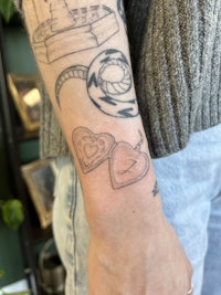 a woman's arm with a tattoo of a heart